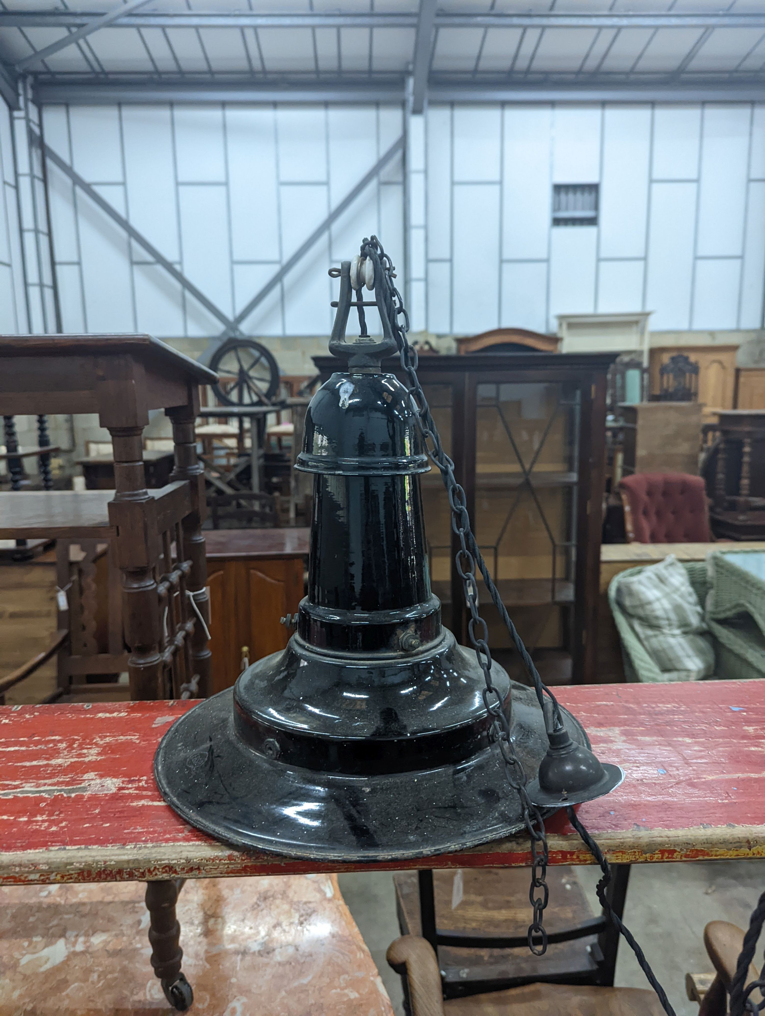 A set of three Continental black enamelled industrial style ceiling shades, height including fittings 39cm